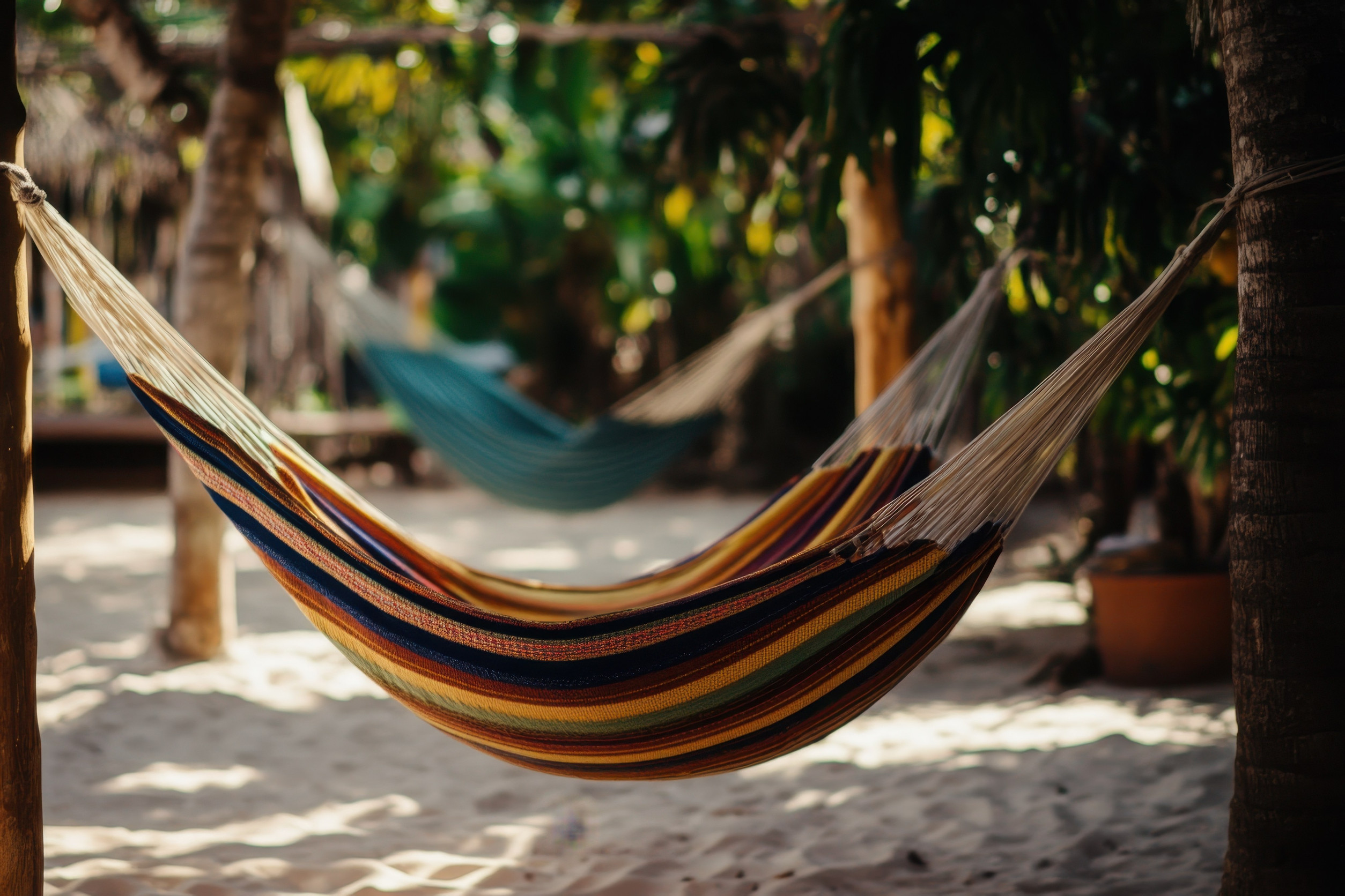 A Vibrant Hammock Sways Gently Between Trees