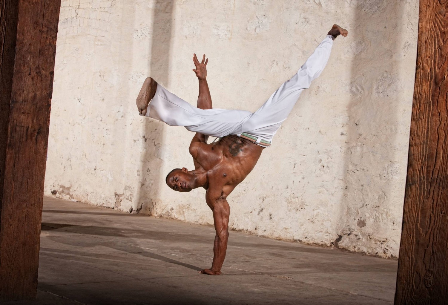Brazilian Man Performing A Capoeira Kick