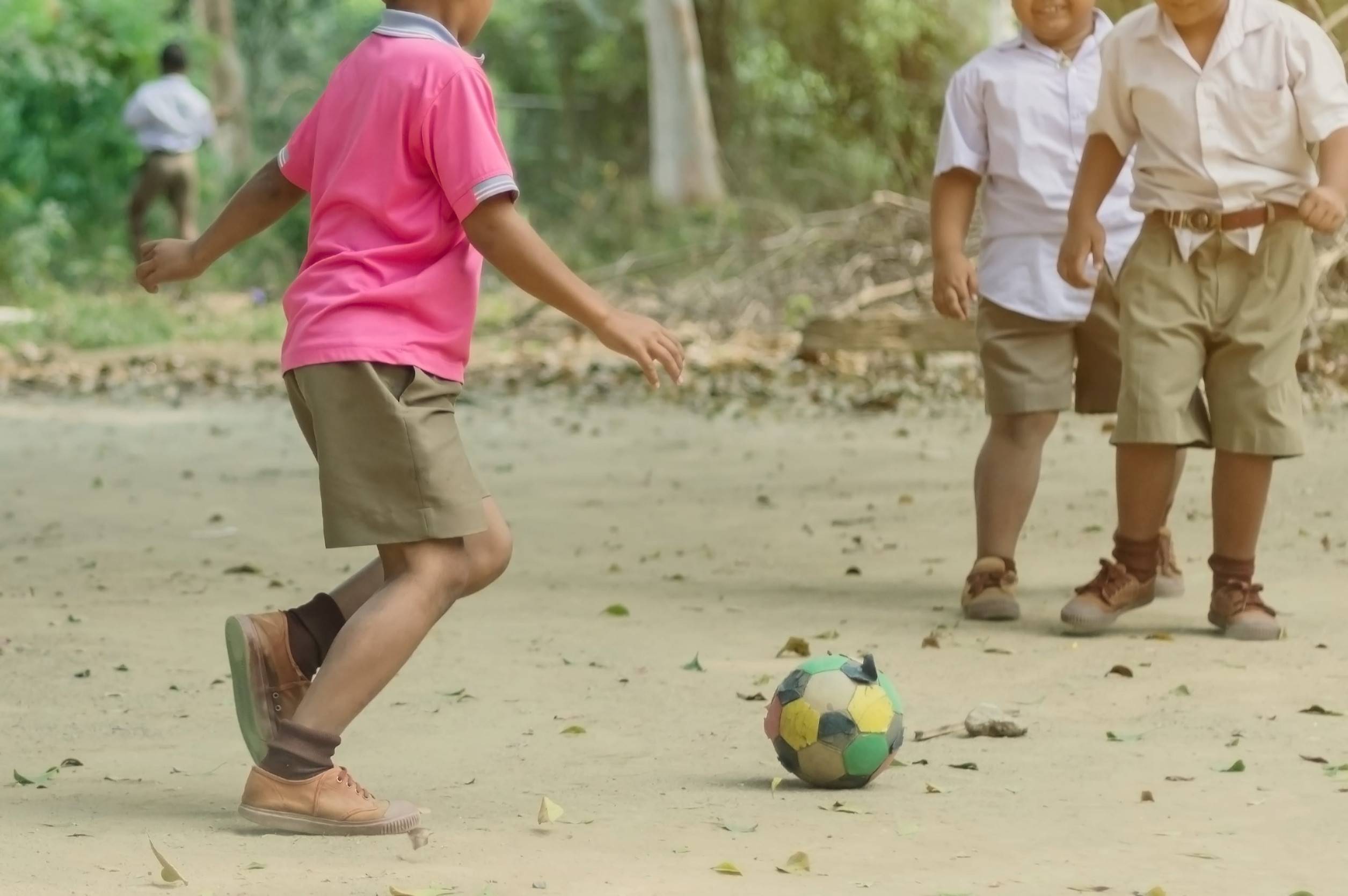 Children Playing With A Football