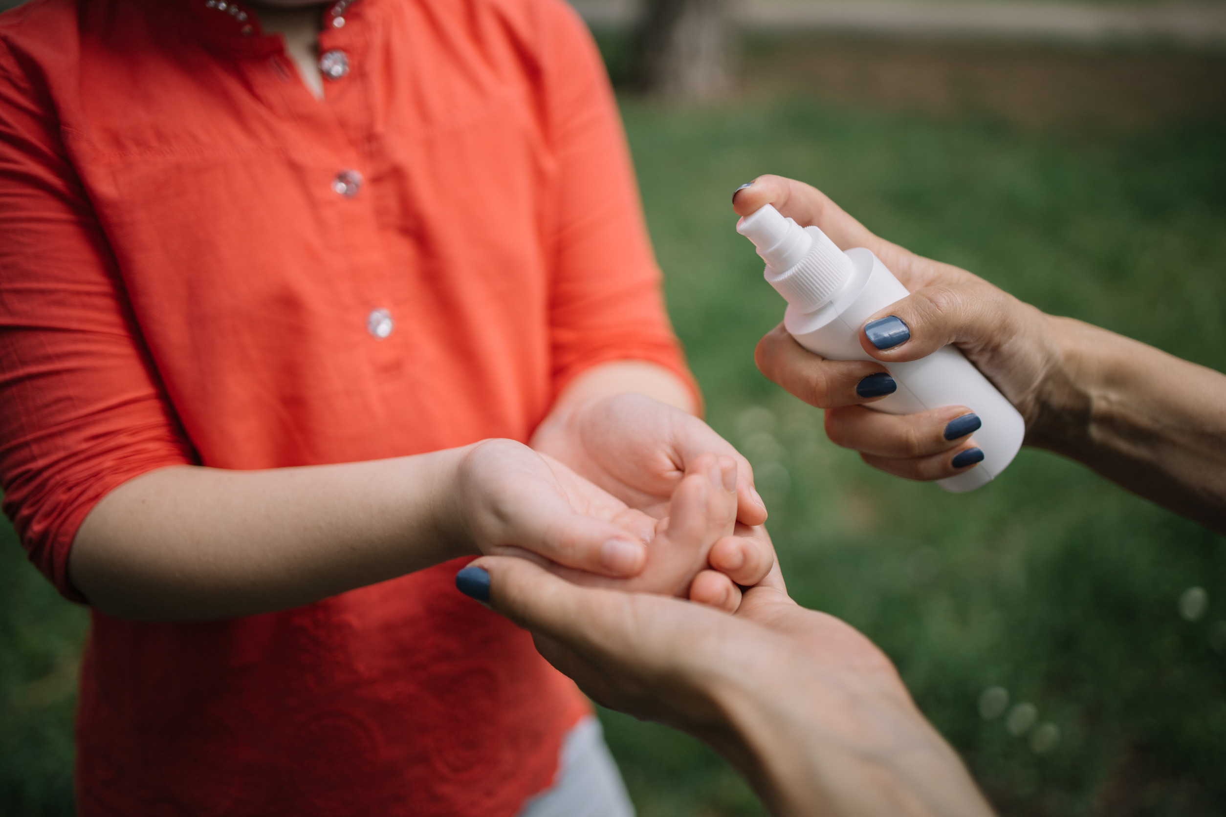 Cropped People Disinfecting Hands With Antiseptic Spray