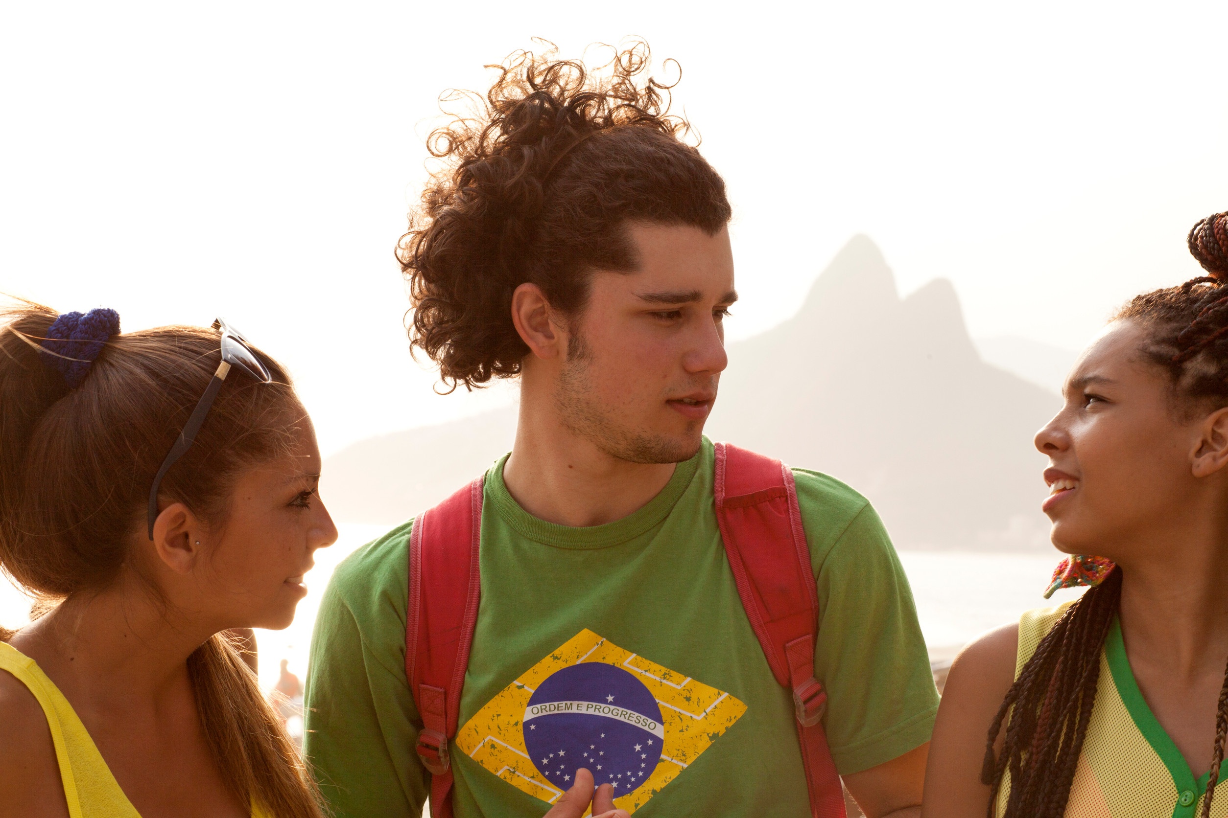 Three Young Adult Friends Chatting On Ipanema Beach