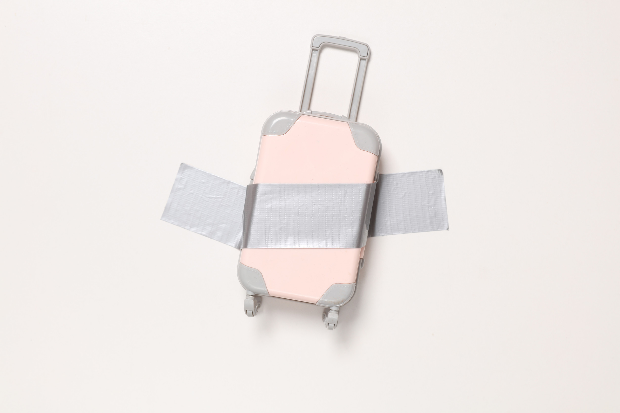 Travel Luggage Fixed With Adhesive Tape On White Background