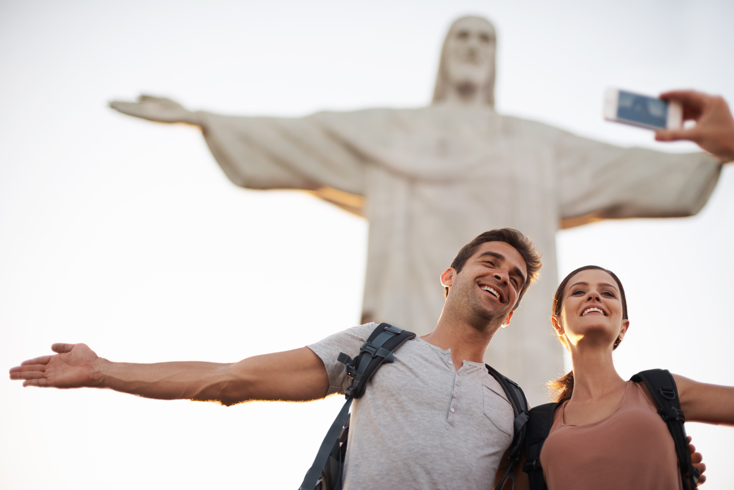 Young Couple Taking Photos At The Christ The Redeemer Statue